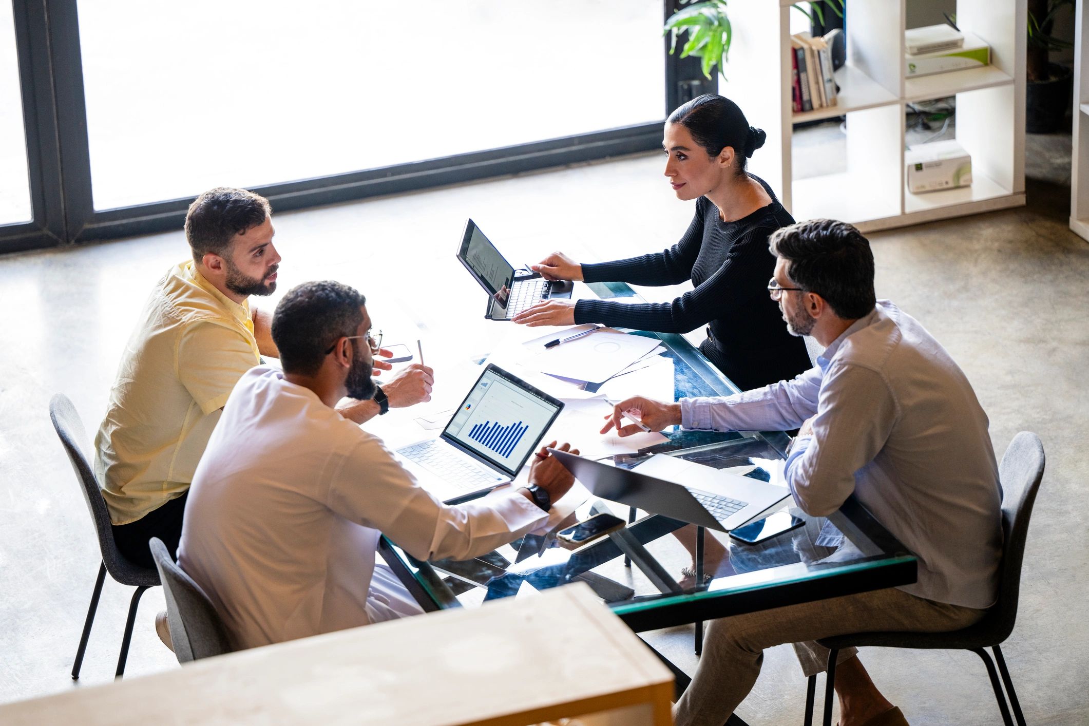 Consultants collaborating around a table in a modern office